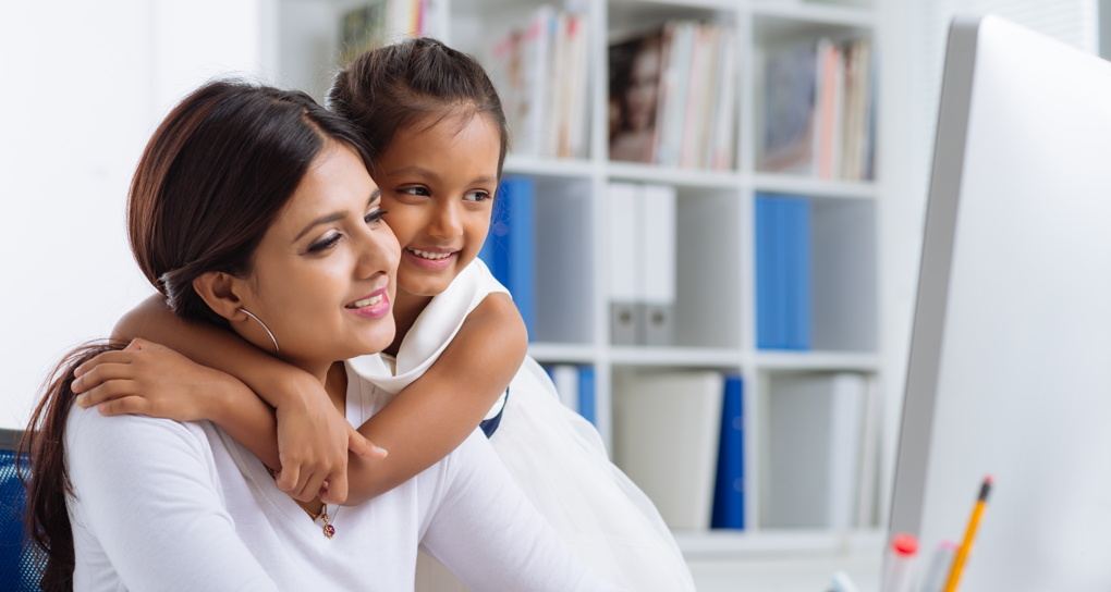 young girl embracing mother"