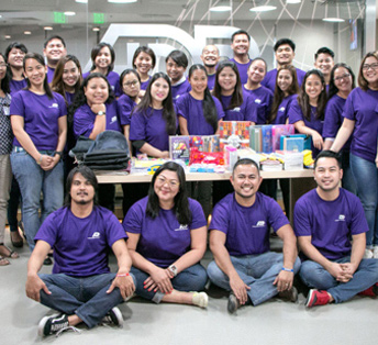 large group of ADP associates wearing purple T-shirts