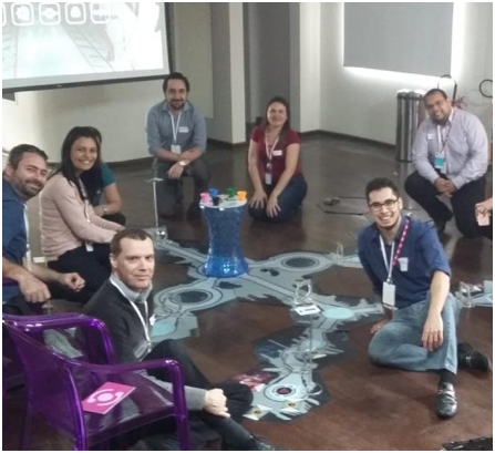 small group of ADP associates sitting on the floor playing a game