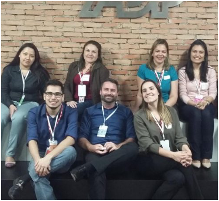small group of ADP associates seated under the ADP wall signage