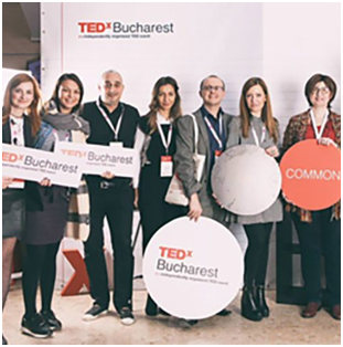 group of ADP associates holding TEDx Bucharest signage
