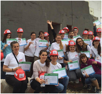 group of ADP associates wearing red hardhats and white T-shirts