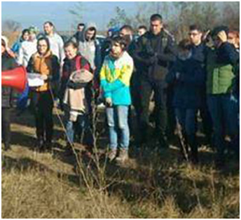 group of ADP associates standing outdoors in the woods