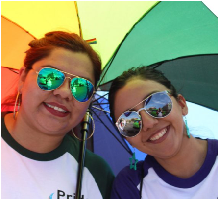 two ADP associates under a rainbow umbrella