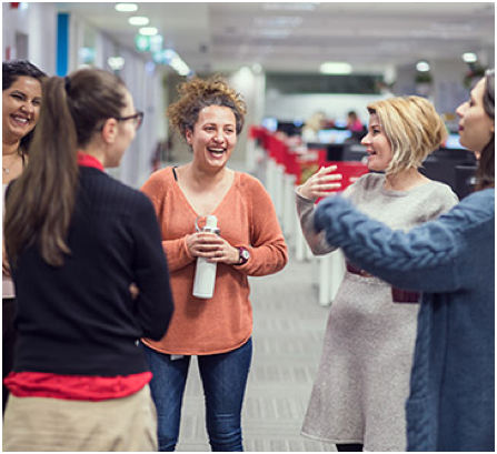 small group of ADP associates socializing in the office