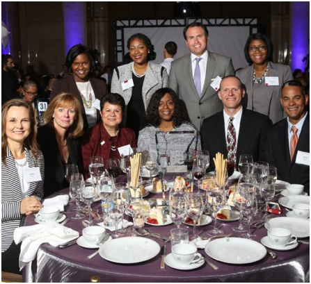 group of ADP associates formally dressed and seated at a banquet table