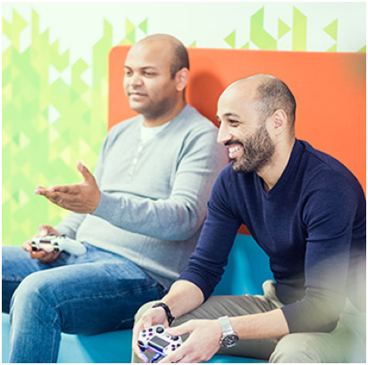 two ADP associates with game controllers in their hands