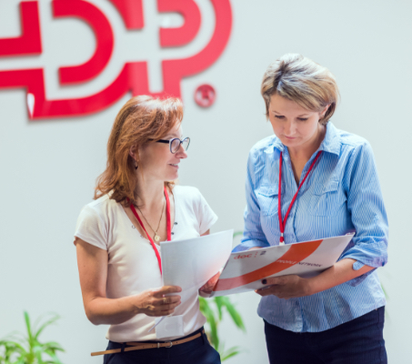 two ADP associates looking over some documents.