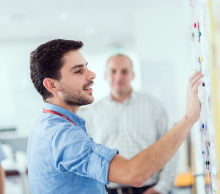 ADP associate working on a whiteboard
