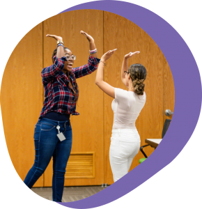 two people high-fiving above their heads